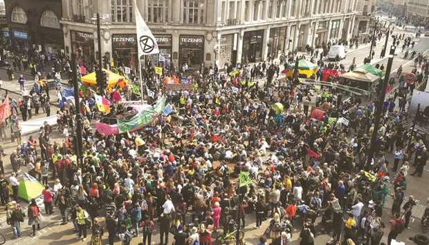 Climate change activists blockade Oxford Circus on the third day of an environmental protest by the Extinction Rebellion group in London yesterday.