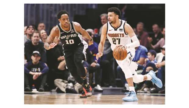 Denver Nuggets guard Jamal Murray (right) controls the ball as San Antonio Spurs guard DeMar DeRozan defends in the third quarter in game two of the first round of the 2019 NBA playoffs at the Pepsi Center. PICTURE: USA TODAY Sports