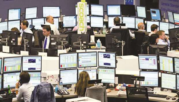 Brokers work at the Frankfurt Stock Exchange. Frankfurtu2019s DAX 30 closed 0.4% up at 12,153.07 points yesterday.