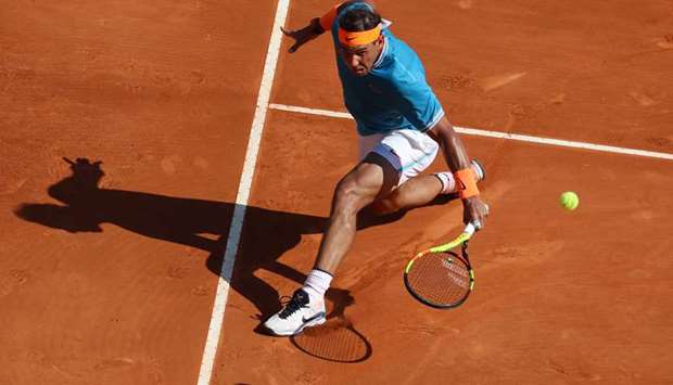Spainu2019s Rafael Nadal plays a backhand return to Spainu2019s Roberto Bautista Agut during their Monte-Carlo ATP Masters match in Monaco yesterday. (AFP)