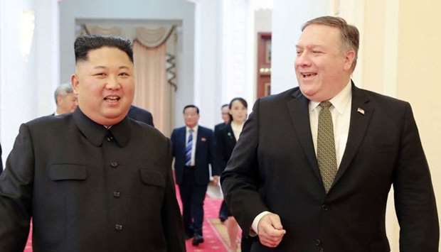 North Korea's leader Kim Jong Un (L) with US Secretary of State Mike Pompeo (R)
