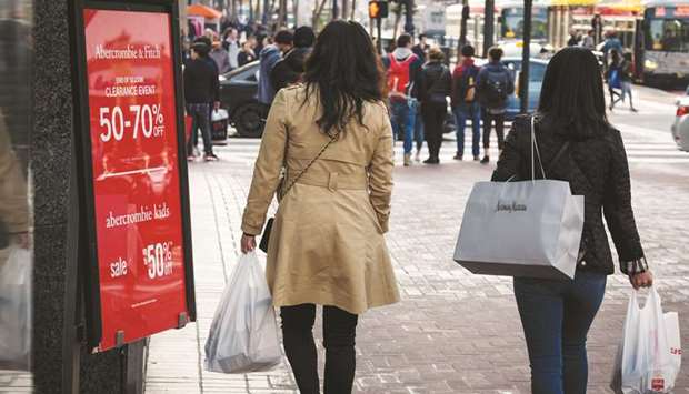 Shoppers carry bags on Market Street in San Francisco. The US Commerce Department said retail sales surged 1.6% last month.