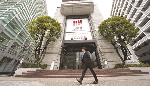 A pedestrian walks past the Tokyo Stock Exchange building, operated by Japan Exchange Group. Tokyo index closed down 0.8% yesterday.
