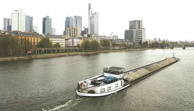 A barge sails on the River Main as skyscrapers stand in the financial district beyond in Frankfurt. Another major source of concern is the German economy, which this year is predicted to see the weakest expansion in six years.