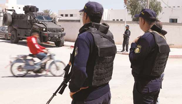 Police officers stand guard in the town of Ben Guerdane, near the Libyan border, Tunisia on Tuesday. The government has been struggling to cure a host of ills ranging from the impact of militant attacks on tourism to weak growth and the dearth of foreign investment.