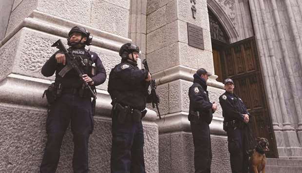 Members of the New York Police Department (NYPD) are seen yesterday outside St Patricku2019s Cathedral on 5th Avenue.