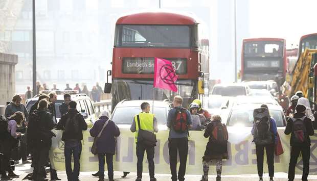 Climate change activists block traffic on Vauxhall Bridge in London yesterday.