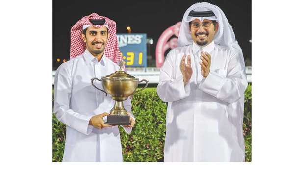 Qatar Racing and Equestrian Club CEO Nasser Sherida al-Kaabi (right) with the Al Jeryan Stud representative after AJS Jood won the Qatari Breeders Cup at the Al Rayyan Park yesterday. PICTURES: Juhaim