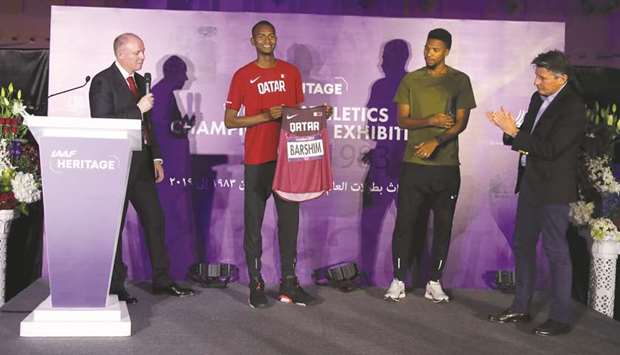 IAAF president Sebastian Coe (right) applauds as Qatari high-jumper Mutaz Barshim (second from left) donates his London 2012 Olympic Games competition vest and number in presence of compatriot and 400m hurdles star Abderrahman Samba (second from right) at the IAAF Heritage World Athletics Championships Exhibition opening ceremony at Dohau2019s City Centre Mall yesterday.