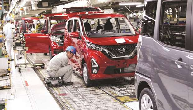 An employee works on the assembly line of the Nissan Motor Company.