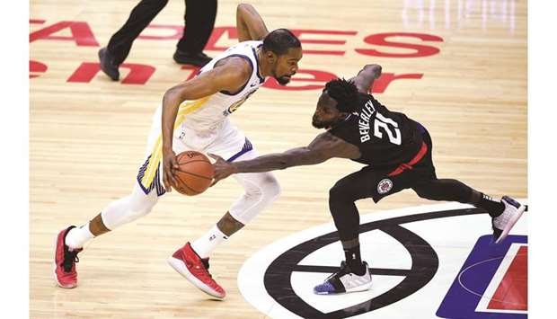 Golden State Warriors forward Kevin Durant moves the ball while Los Angeles Clippers guard Patrick Beverley (21) defends during the first-half in the game three of the first round of the 2019 NBA Playoffs at Staples Center. PICTURE: USA TODAY Sports