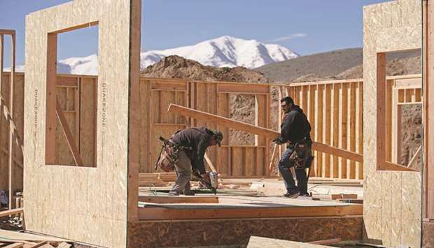 Workers build a floor at a home under construction in Saratoga Springs, Utah. The second straight monthly decline in homebuilding reported by the US Commerce Department yesterday probably reflected in part massive flooding in the Midwest, with housing starts in the region plunging to levels last seen in early 2015.