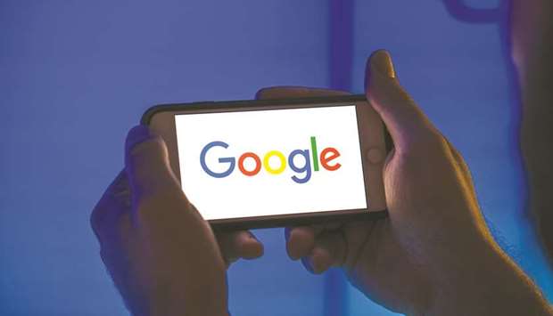 The logo of Google appears on a smartphone in London. Google and Amazon said on Thursday they would begin letting each othersu2019 video services appear on their respective streaming gadgets.