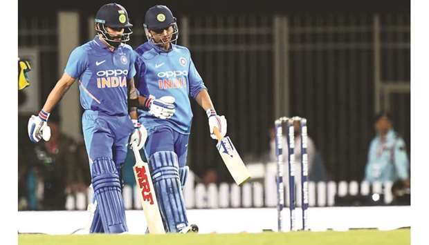 In this March 8, 2019, picture, Indian captain Virat Kohli (left) speaks to teammate Mahendra Singh Dhoni during the third ODI against Australia in Ranchi, India. (AFP)