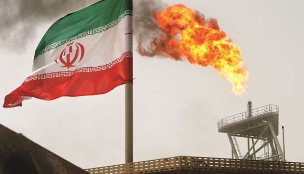 A gas flare on an oil production platform in the Soroush oil fields is seen alongside an Iranian flag (file). Most Asian buyers are avoiding Iran oil imports for next month as it remains unclear what will happen to the exemptions that are set to expire in the first week of May, according to people with knowledge of the matter.
