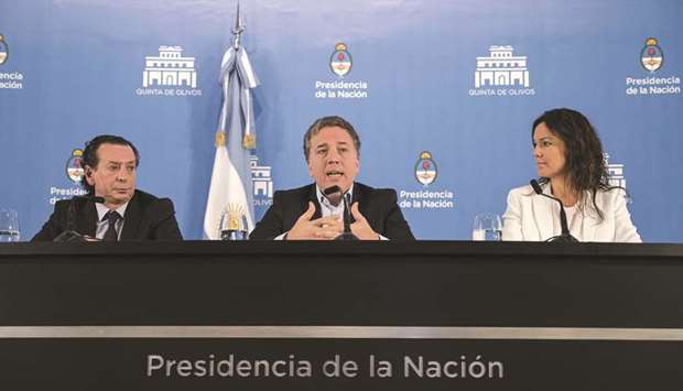 Argentinian Economy Minister Nicolas Dujovne (centre), talks during a press conference next to Argentinian Production and Work Minister, Dante Sica (left), and Argentinian Health and Social Development Minister, Carolina Stanley. President Mauricio Macri announced anti-inflationary measures to reactivate the economy in recession-hit Argentina.