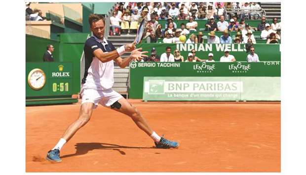 Russiau2019s Daniil Medvedev hits a return against Serbiau2019s Novak Djokovic during their Monte Carlo Masters quarter-final yesterday. (AFP)