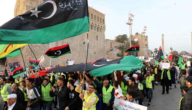 Libyan protesters attend a demonstration to demand an end to the Khalifa Haftar's offensive against Tripoli, in Martyrs' Square in central Tripoli, Libya yesterday.
