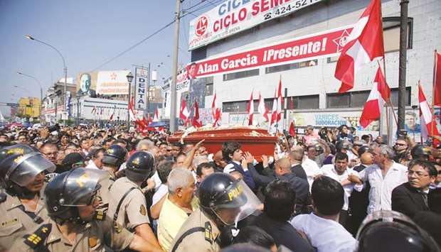 Friends and family carry the coffin with the remains of Peruu2019s former president Alan Garcia in Lima, Peru.