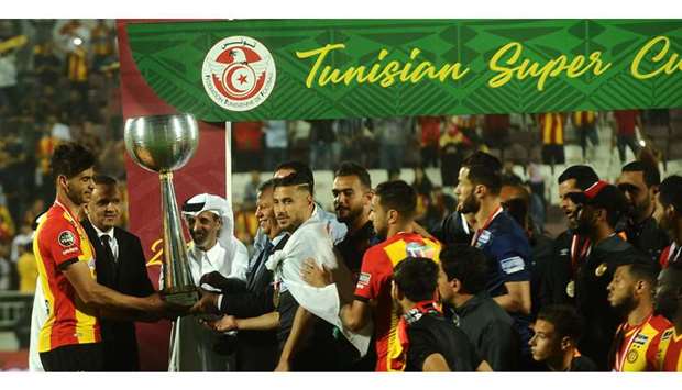 Qatar Football Association president Sheikh Hamad bin Khalifa bin Ahmed al-Thani and Tunisian Football Federation (FTF) president Wadii Jarii present the winneru2019s trophy to Esperance Sportive de Tunis after they won the Tunisian Super Cup title with a win over Club Athletique Bizertin at Al Duhail Stadium yesterday. PICTURE: Shemeer Rasheed