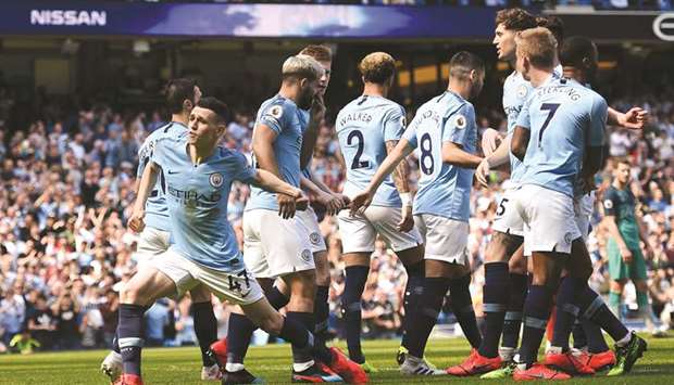 Manchester Cityu2019s English midfielder Phil Foden (L) celebrates scoring against Tottenham Hotspur at the Etihad Stadium in Manchester yesterday.