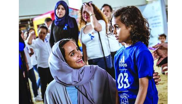 HE Sheikha Hind interacts with a child at QFu2019s World Autism Awareness Day event