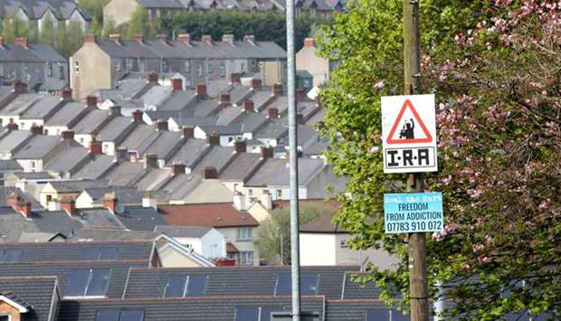 A picture shows an Irish Republican Army (IRA) sniper warning sign overlooking the Bogside area of Derry in Northern Ireland. Two teenagers have been arrested over the killing of journalist Lyra McKee in Derry, Northern Ireland, police said yesterday.