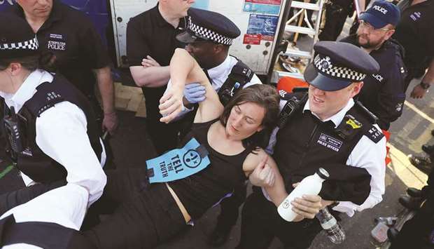 An activist is detained yesterday during the u2018Extinction Rebellionu2019 protest on Waterloo Bridge in London.