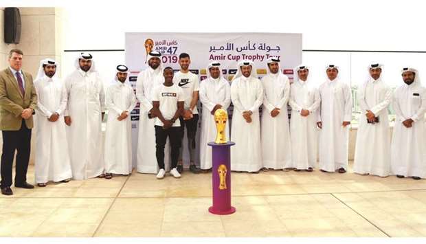 Players and officials pose with the Amir Cup Trophy during its stop at Msheireb Properties yesterday.