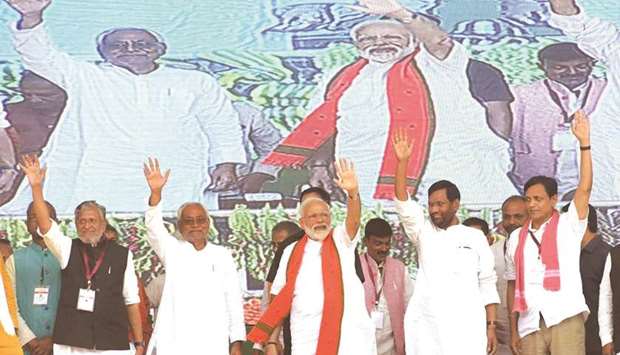 Prime Minister Narendra Modi, Bihar Chief Minister Nitish Kumar and other leaders wave at supporters during a public rally in Araria, Bihar, yesterday.