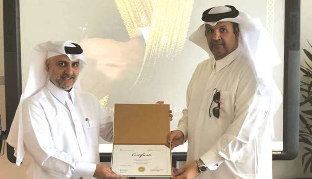Dr Khalid al-Horr awarding the first u2018Powerful Leader Certificateu2019 to Khalid Jassim al-Jassim.