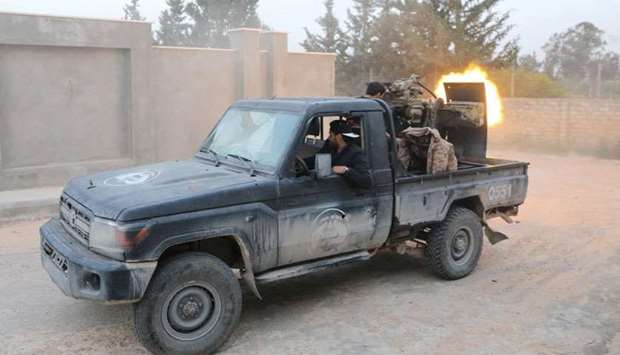 Members of the Libyan internationally recognised government forces fire during fighting with Eastern forces in Ain Zara