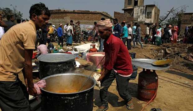 Villagers prepare food for the victims affected by the storm in Bara district
