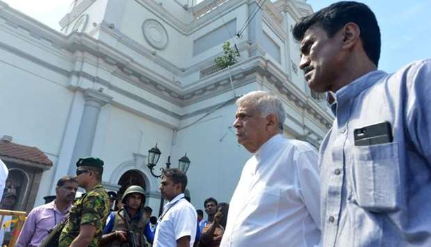 Sri Lankan Prime Minister Ranil Wickremasinghe (2nd R) arrives to visit the site of a bomb attack at St. Anthony\'s Shrine in Kochchikade in Colombo