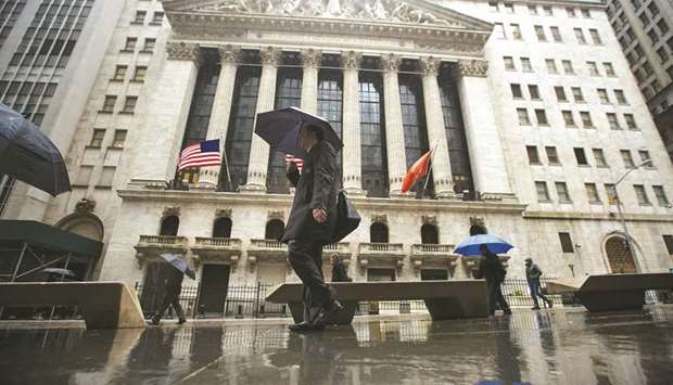 Pedestrians walking past the New York Stock Exchange building. Electronic trading on Wall Street is still a relatively small part of a market dominated by dealers, but its share of trading is growing.