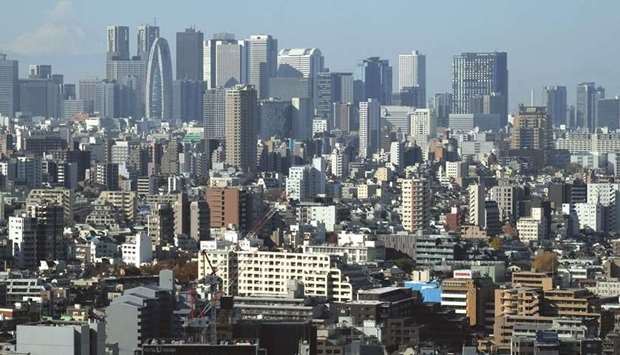 Skyscrapers in Tokyou2019s Shinjuku area (top) and downtown streets. Japanu2019s government could postpone for a third time a sales tax increase currently planned for October if economic conditions deteriorate, a senior lawmaker close to Prime Minister Shinzo Abe said.