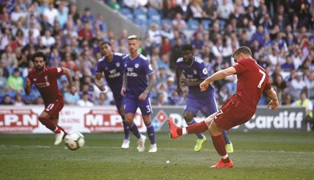 Liverpoolu2019s James Milner scores their second goal from the penalty spot against Cardiff yesterday.