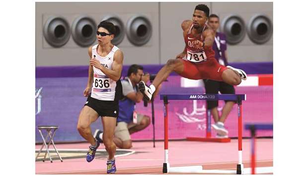 Abderrahman Samba (R) of Qatar and Lim Chanho (L) of South Korea compete in the 400m menu2019s hurdles heats yesterday.