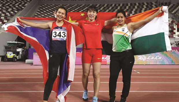 Lyu Huihui of China (C), Annu Rani of India (R), and Natta Nachan of Thailand (L), celebrate winning first, second, and third place respectively in the womenu2019s javelin throw during the 23rd Asian Athletics Championships at Khalifa International Stadium in Doha yesterday. PICTURES: Noushad Thekkayil and agencies