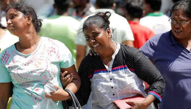 Relatives of victims react at a police mortuary, after bomb blasts ripped through churches and luxury hotels on Easter, in Colombo, Sri Lanka