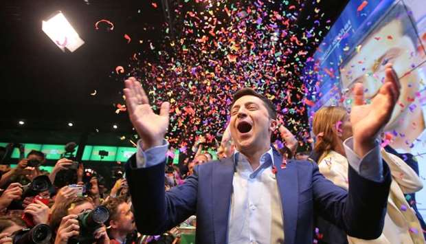 Ukrainian presidential candidate Volodymyr Zelenskiy reacts following the announcement of the first exit poll in a presidential election at his campaign headquarters in Kiev
