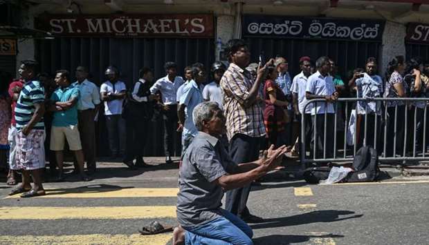 People pray outside the St. Anthony's Shrine in Colombo