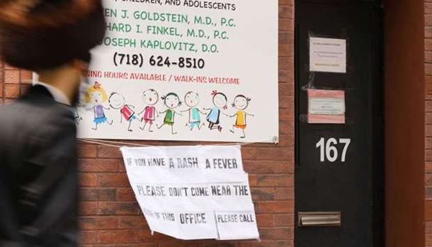 A sign warns people of measles in Williamsburg