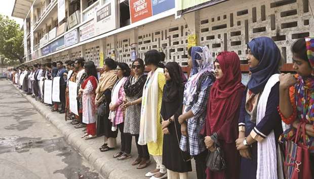 Members of the Transparency International Bangladesh group stand in a human chain during a protest in Dhaka yesterday, following Nusrat Jahan Rafiu2019s murder by being set on fire after she had reported a sexual assault.