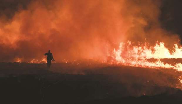 Firefighters tackle a blaze on a moorland above the village of Marsden, northwest England.