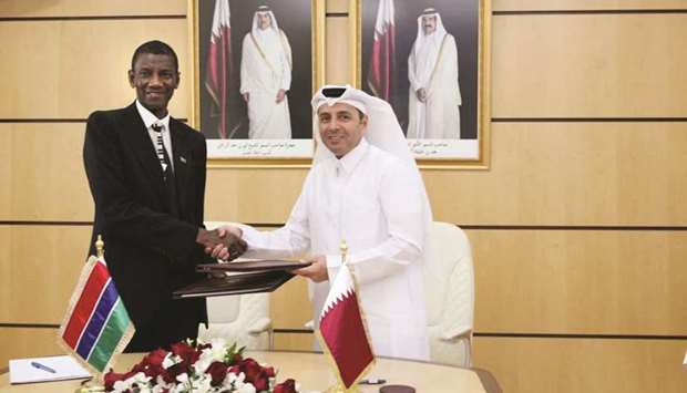 HE Dr Mohamed Abdul Wahed Ali al-Hammadi and Badara Joof shake hands after signing an MoU.
