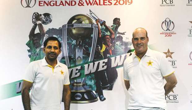 Pakistan captain Sarfraz Ahmed (L) and their South African coach Mickey Arthur pose prior to a press conference in Lahore yesterday.