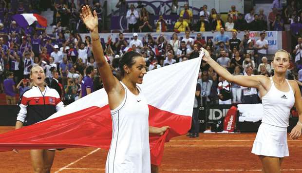 Franceu2019s Kristina Mladenovic (right) and Caroline Garcia celebrate after winning the fifth rubber of the Fed Cup semi-final against Romania in Rouen. (AFP)