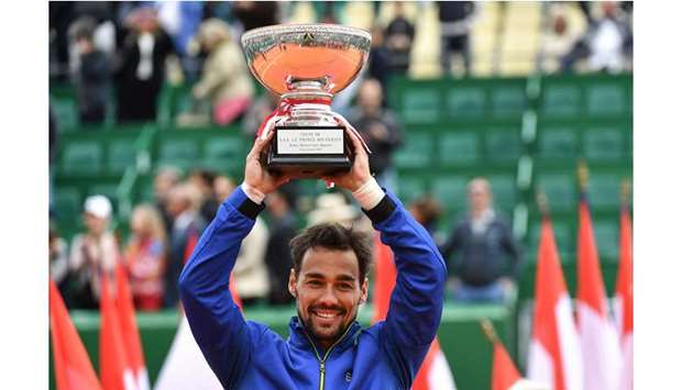 Winner Italyu2019s Fabio Fognini poses with the trophy after winning the Monte Carlo ATP Masters against Serbiau2019s Dusan Lajovic Series in Monaco on Sunday. (AFP)