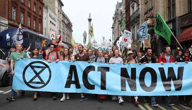 Climate change activists from the group Extinction Rebellion march down Whitehall as they protest in central London